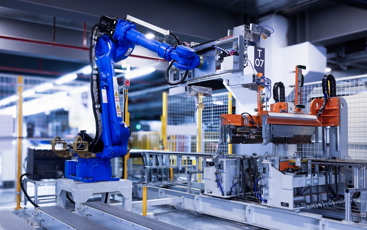 Industrial robotic arm mid-operation on a production line